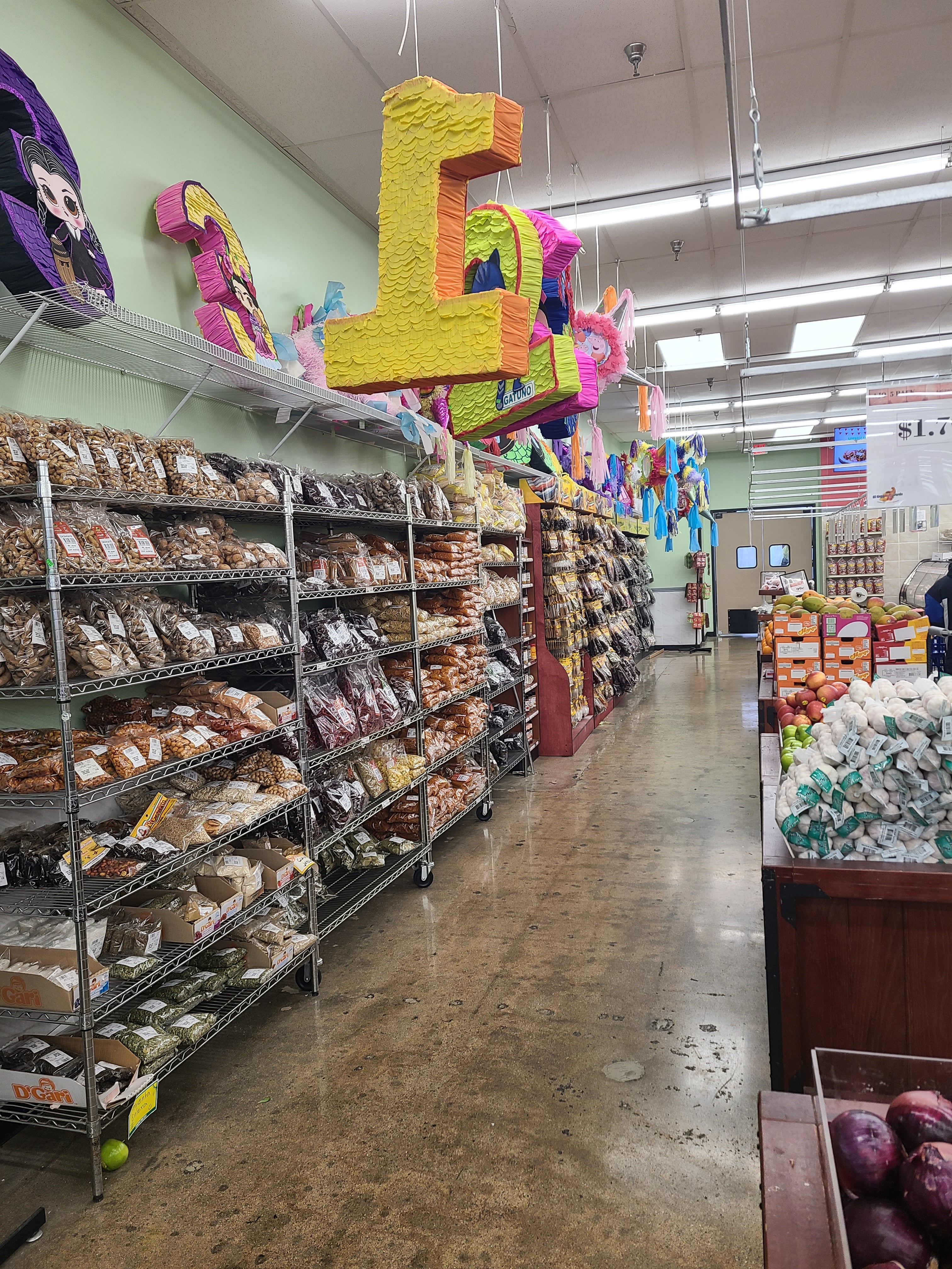 Rows of fresh produce, packaged Hispanic groceries, and colorful piñatas inside El Gran Valle Verde, an authentic Hispanic grocery store in Hamilton, Ohio.