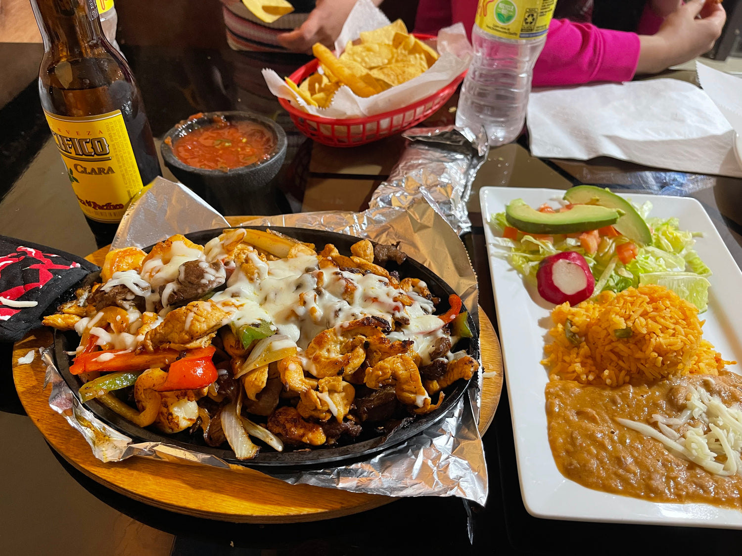 Sizzling fajitas, rice, beans, fresh salad, chips, and salsa served at the Taquería inside El Gran Valle Verde, an authentic Hispanic grocery store in Hamilton, Ohio.