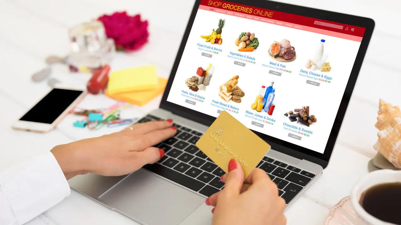 Customer shopping online for groceries from El Gran Valle Verde in Hamilton, Ohio, browsing fresh produce, meats, dairy, and pantry items on a laptop while preparing to place an online order for delivery or pickup.